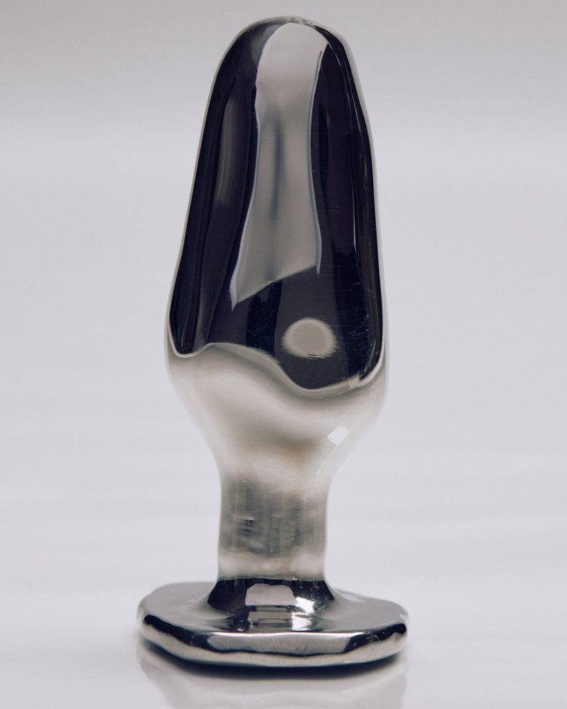 Sleek Jonny lubricant applicator with an elegant design displayed against a white backdrop.